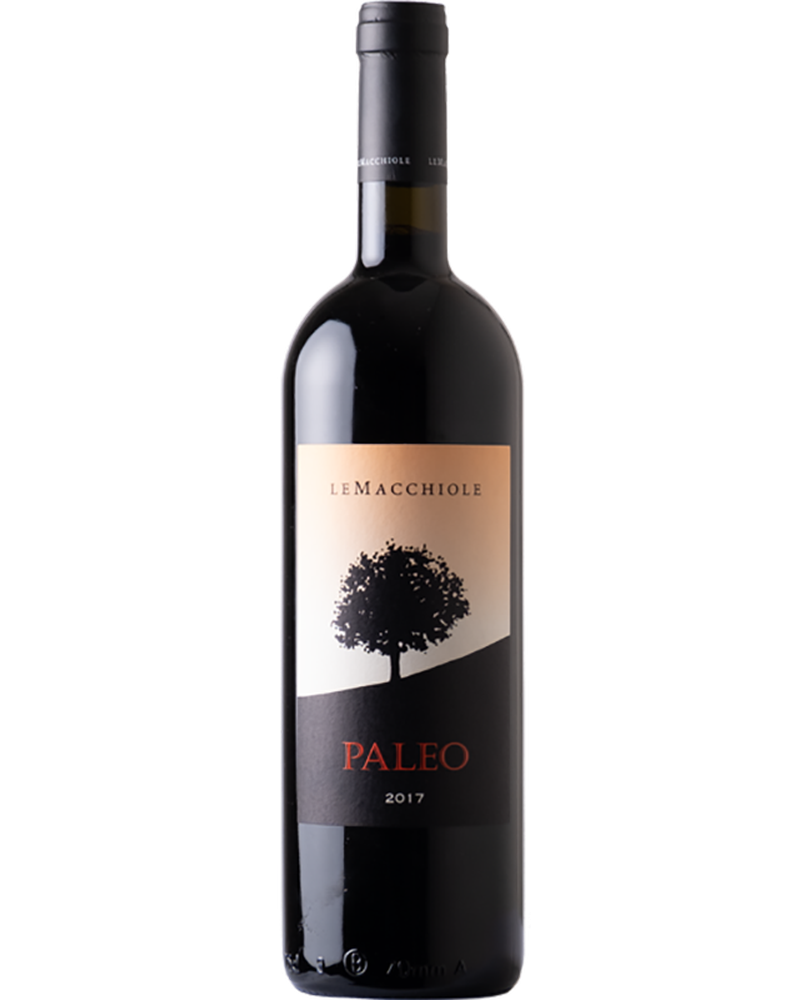 Le Macchiole Paleo Bianco Toscana 2024 IGT bottle with elegant label and white wine in a glass on a wooden table.